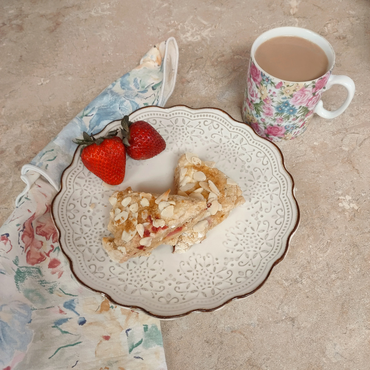 a breakfast of berries with strawberry-almond cheesecake scones